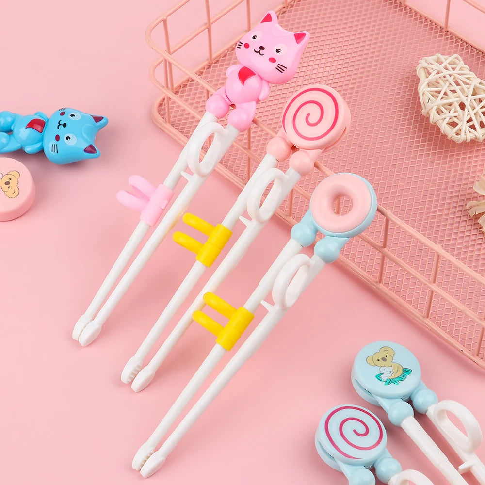 Set of kawaii cartoon-themed chopsticks with colorful ends on a pink background