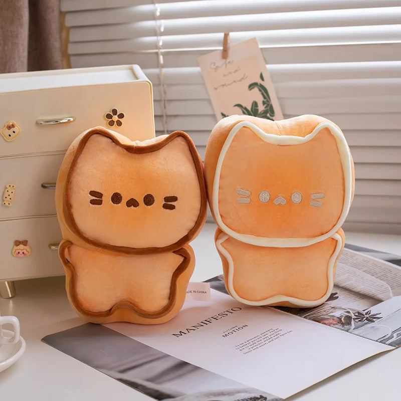Two cute kawaii plush toys resembling toast with animal faces on a desk.