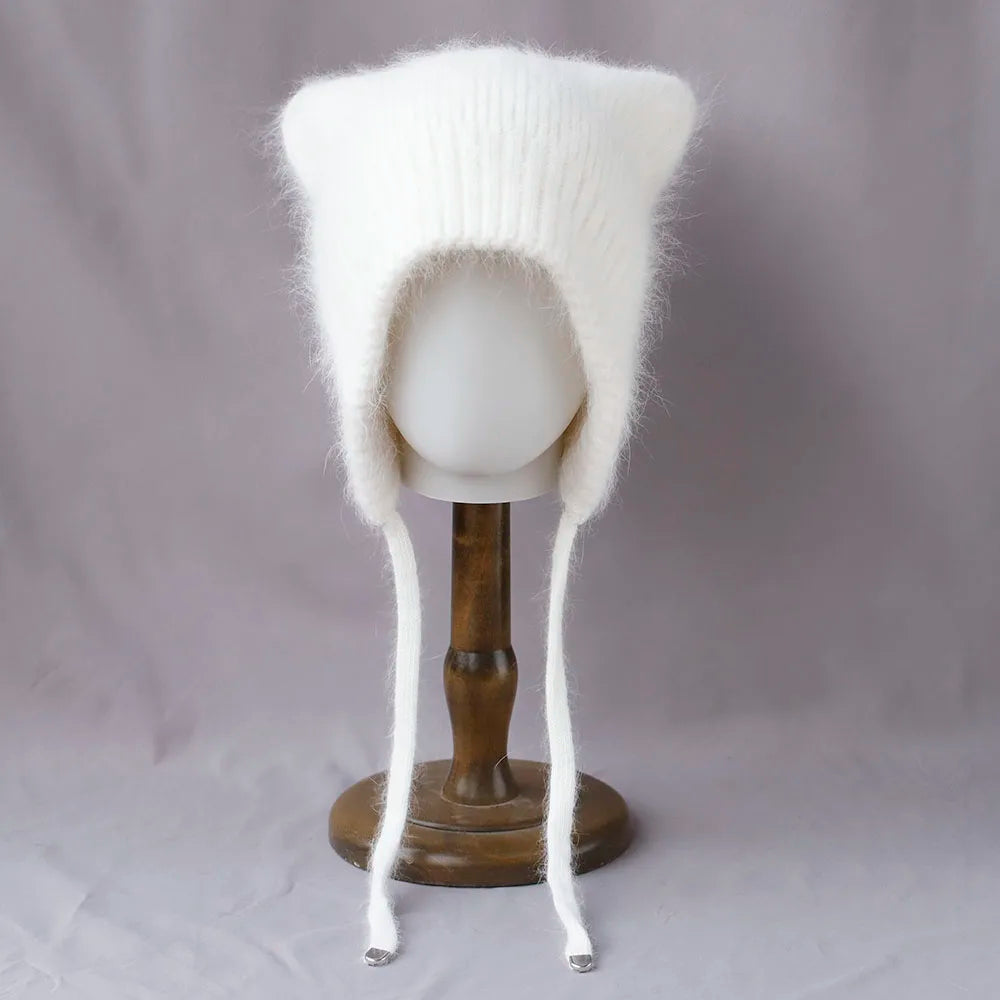 White knitted cat ear Kawaii hat on a mannequin head against a gray background