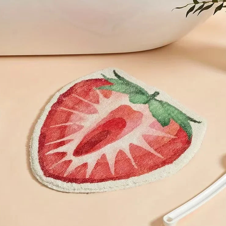 Kawaii strawberry-shaped bath mat on a beige surface with a blurred background