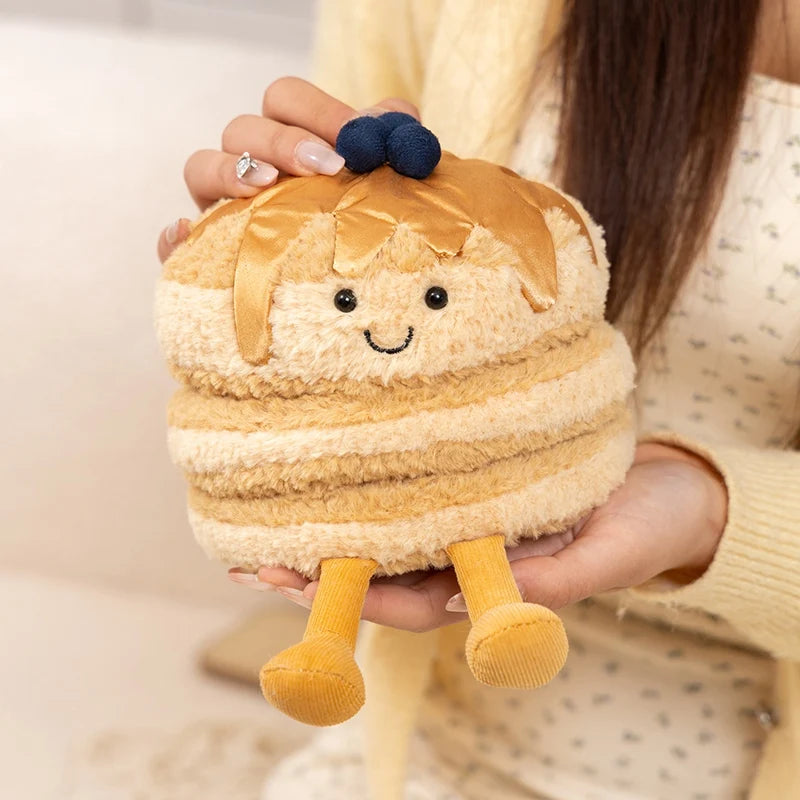 Plush kawaii toy resembling a layered dessert held by a person