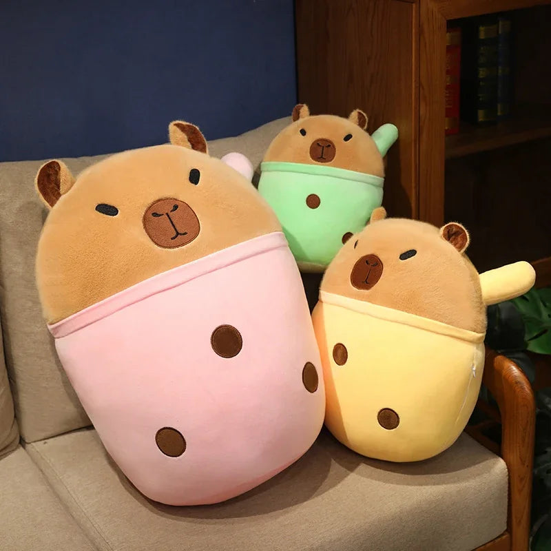 Three cartoon-style kawaii plush toys resembling animals on a couch.