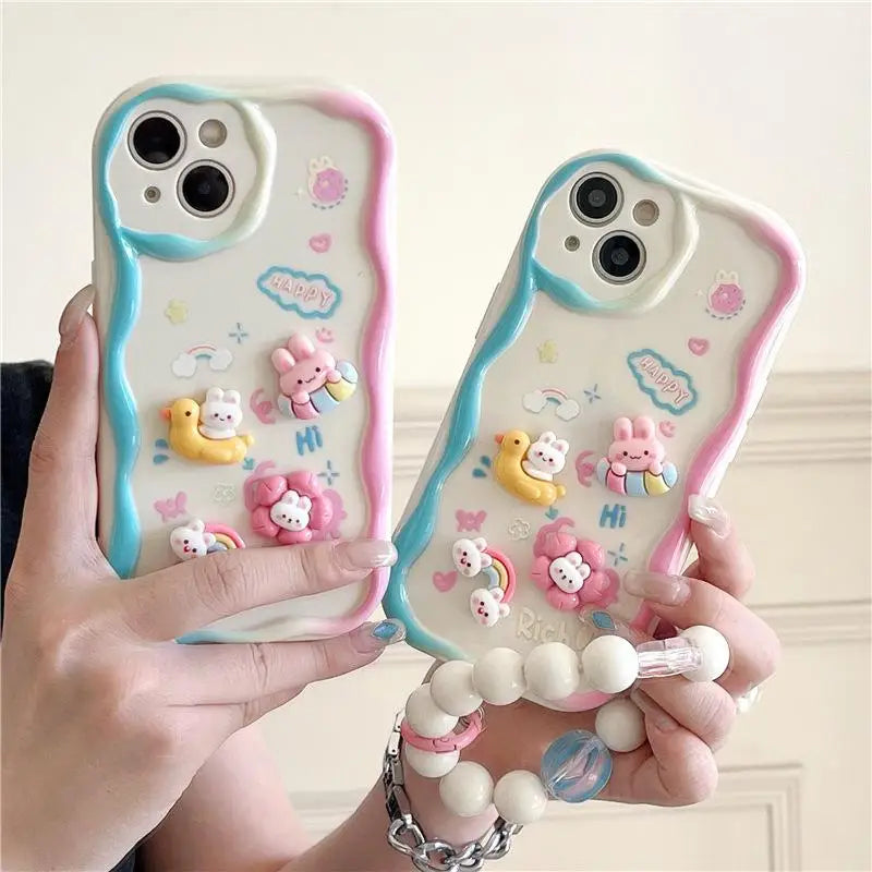 Two phone cases with cute kawaii animal designs held by a person against a light background