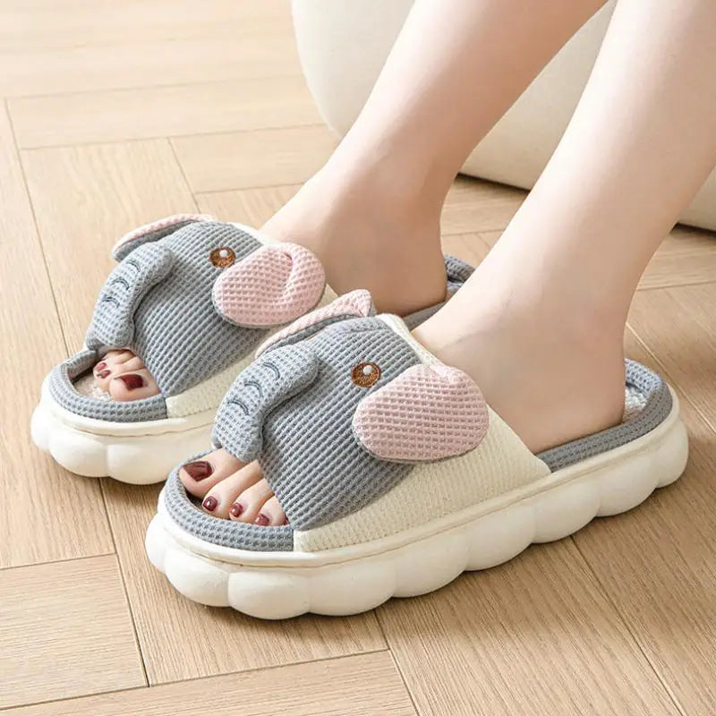 Gray slippers with kawaii pink ears worn on a wooden floor