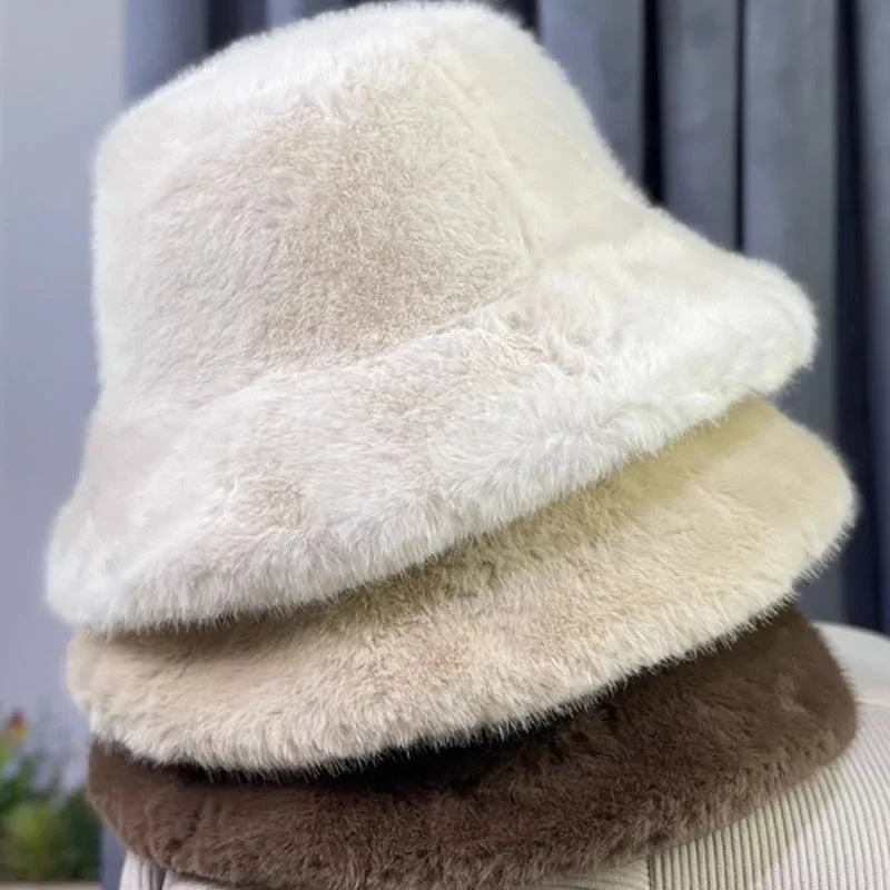 Stack of fluffy Kawaii beanies in beige, white, and brown on a neutral background