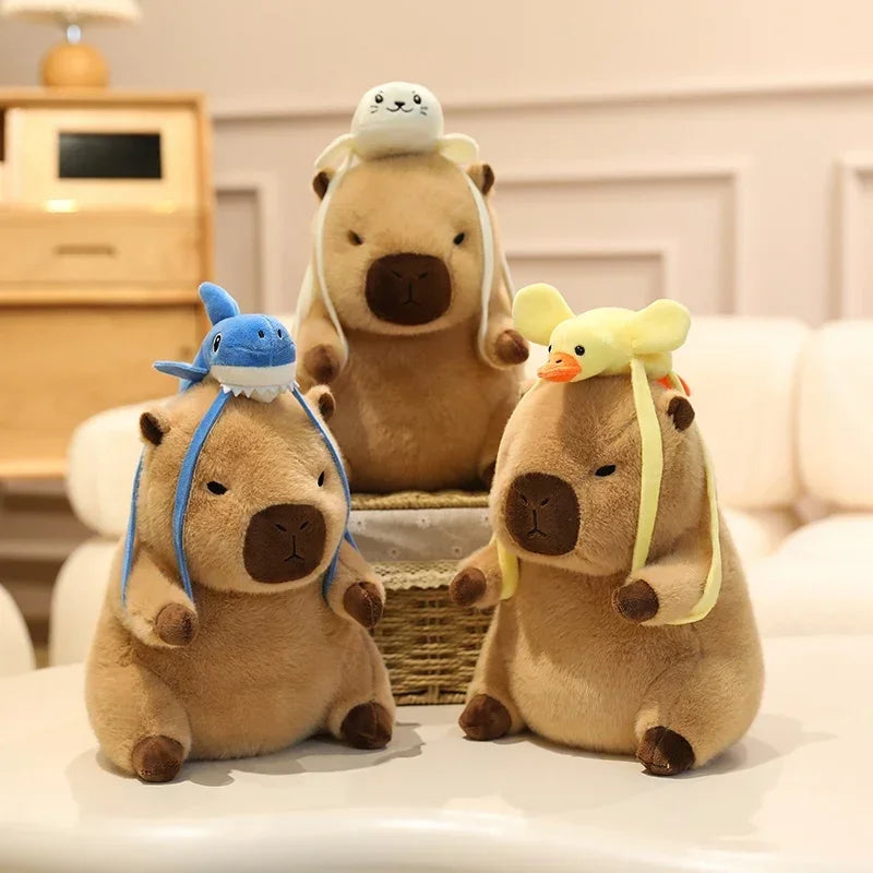 Three kawaii plush toys resembling bears with animal hats on a light-colored surface.