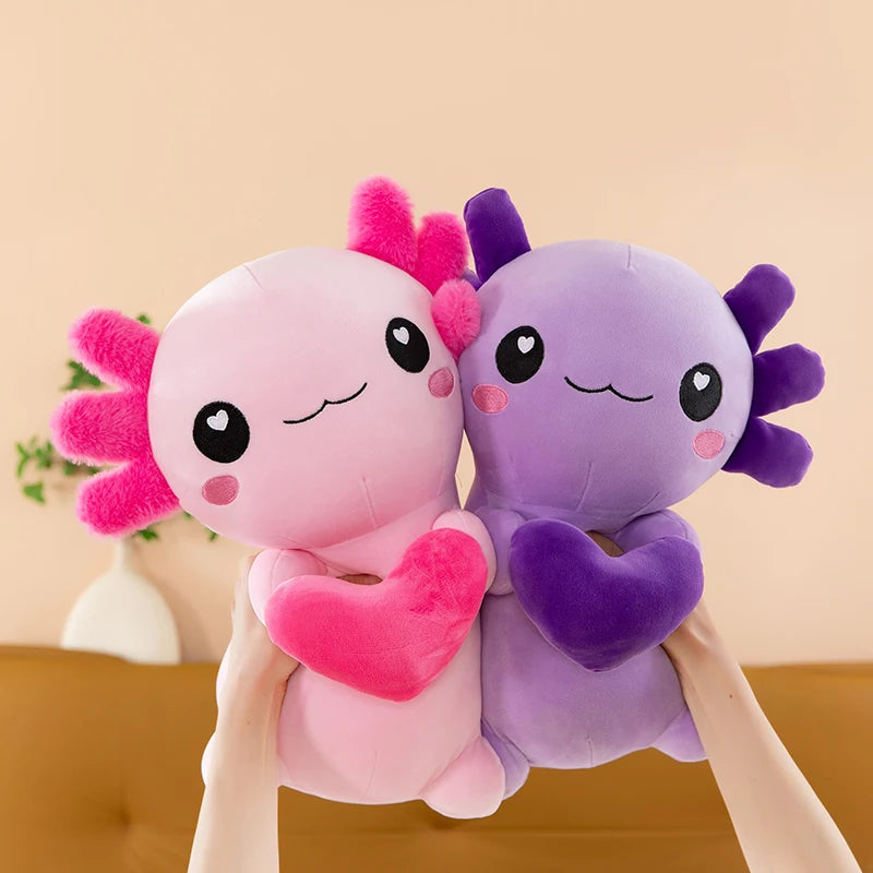 Two cute kawaii plush toys, one pink and one purple, held against a beige background.