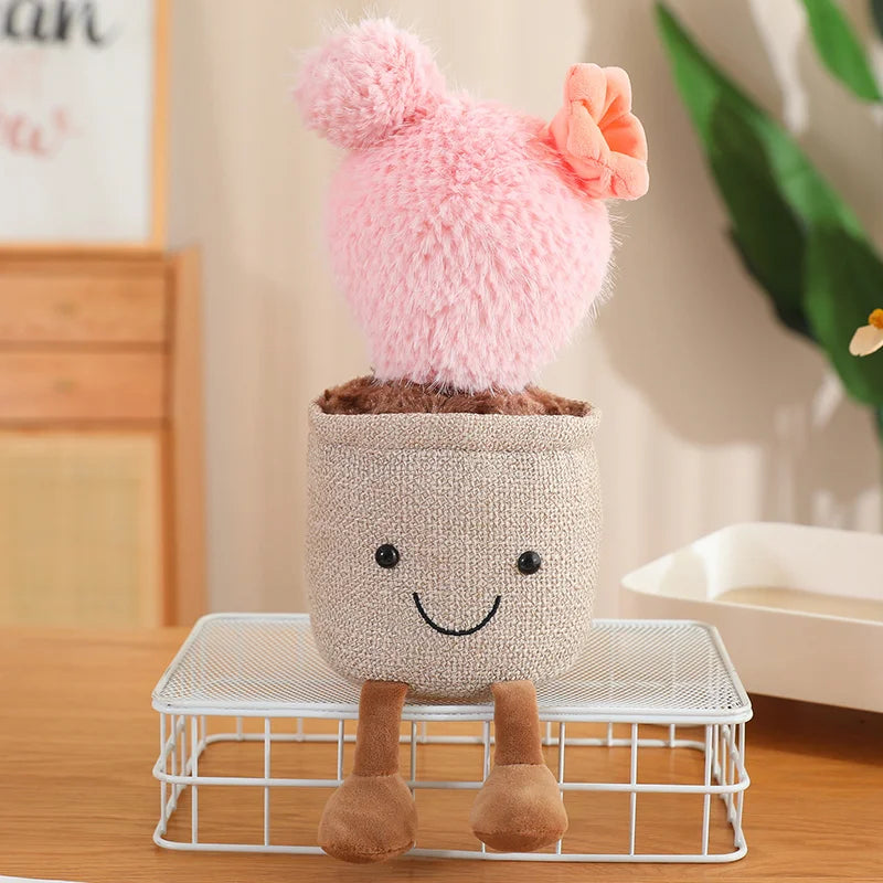 Plush kawaii toy with a pink hat and smiling face on a white stand