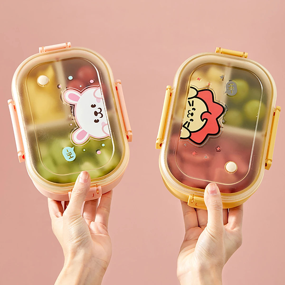 Two kawaii cartoon-themed bento boxes held against a pink background