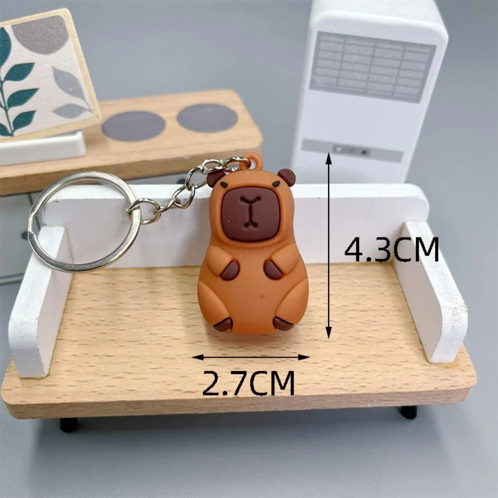 Brown bear-shaped kawaii keychain on a wooden stand with measurements indicated
