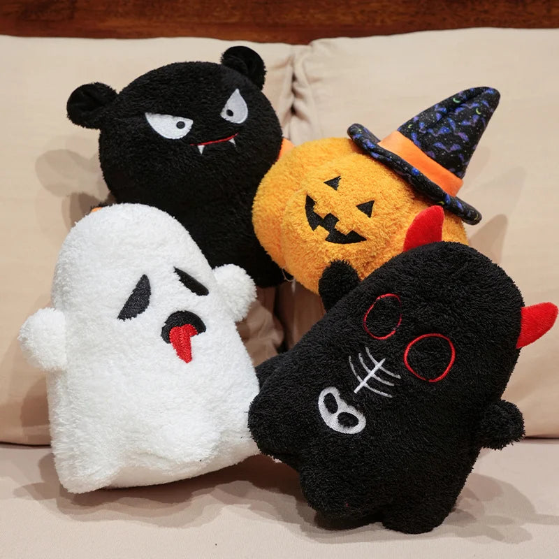 Four Halloween-themed kawaii plush toys on a beige surface.