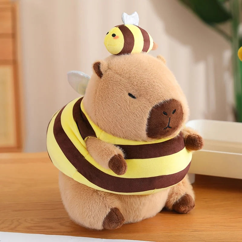 Kawaii plush toy bear wearing a bee costume on a wooden surface