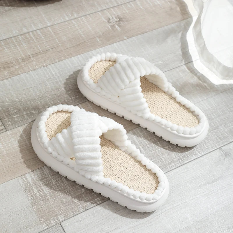 Pair of white kawaii slippers on a wooden floor