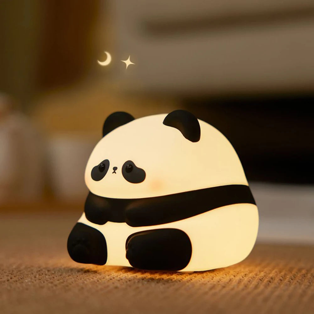 Cute kawaii panda-shaped night light on a wooden surface with a blurred background