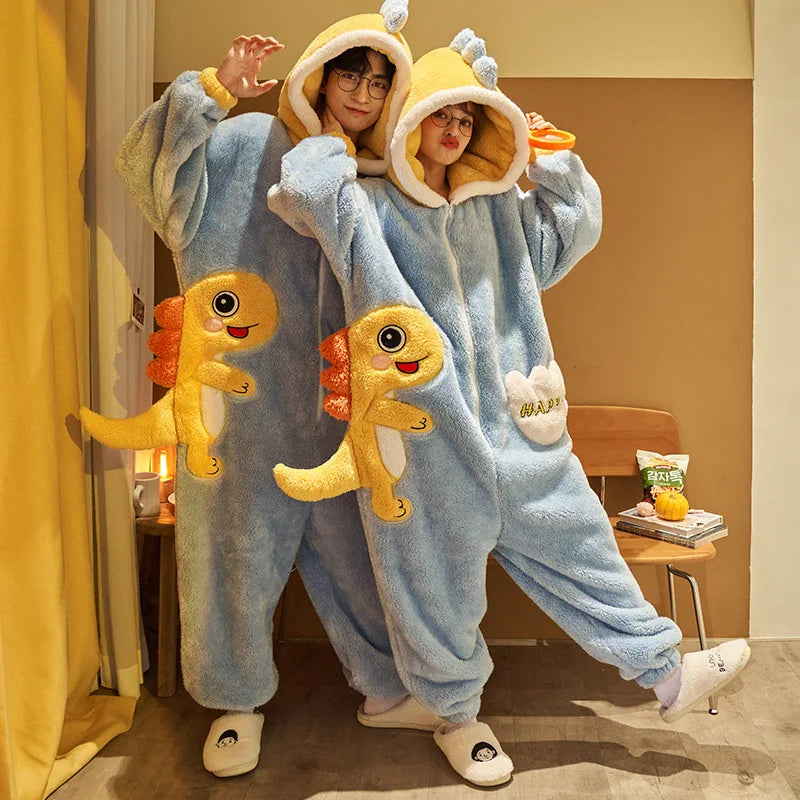 Two people wearing blue kawaii dinosaur-themed onesies in a room.