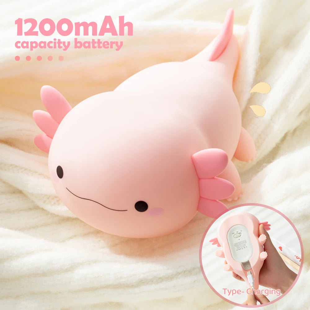 Pink kawaii axolotl-shaped power bank with 1200mAh capacity on a soft fabric background