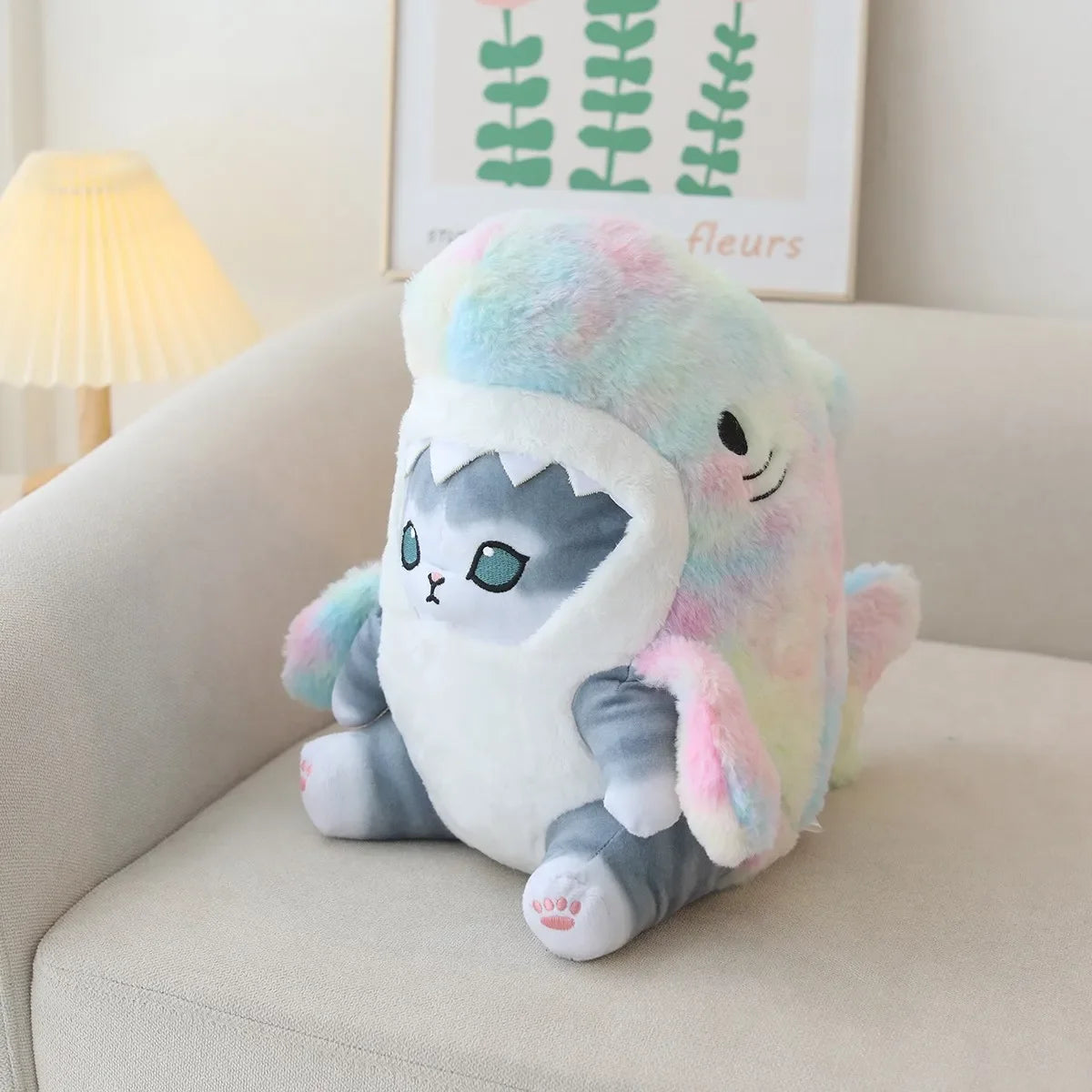 Plush kawaii toy resembling a cat in a colorful cloud on a couch