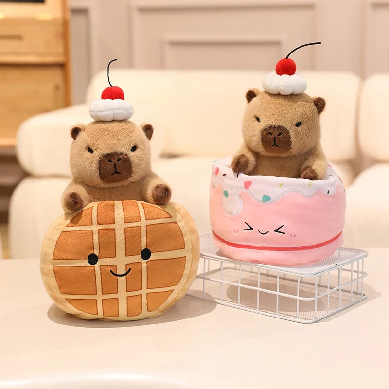 Two kawaii plush toys resembling a bear and a cake with a cherry on top, sitting on a surface.