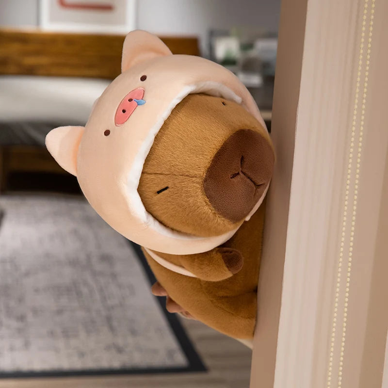Kawaii plush toy resembling a bear with a brown body and pink face peeking out from behind a wooden door.
