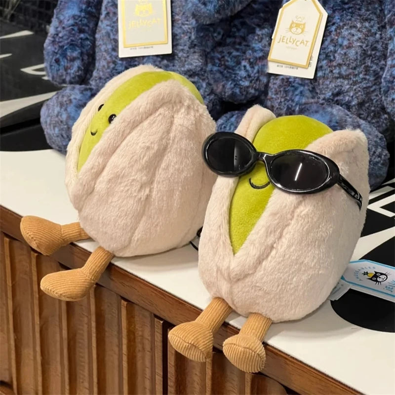 Two kawaii plush toys resembling pears with sunglasses on a wooden surface.