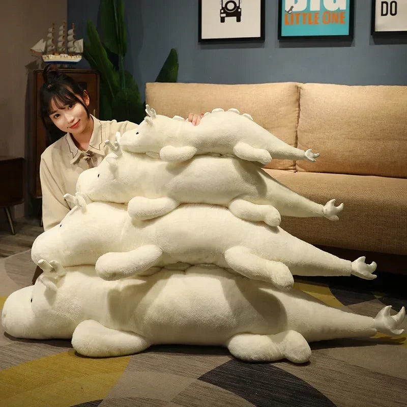 Person holding a large stack of white kawaii plush toys resembling dragons on a living room floor.