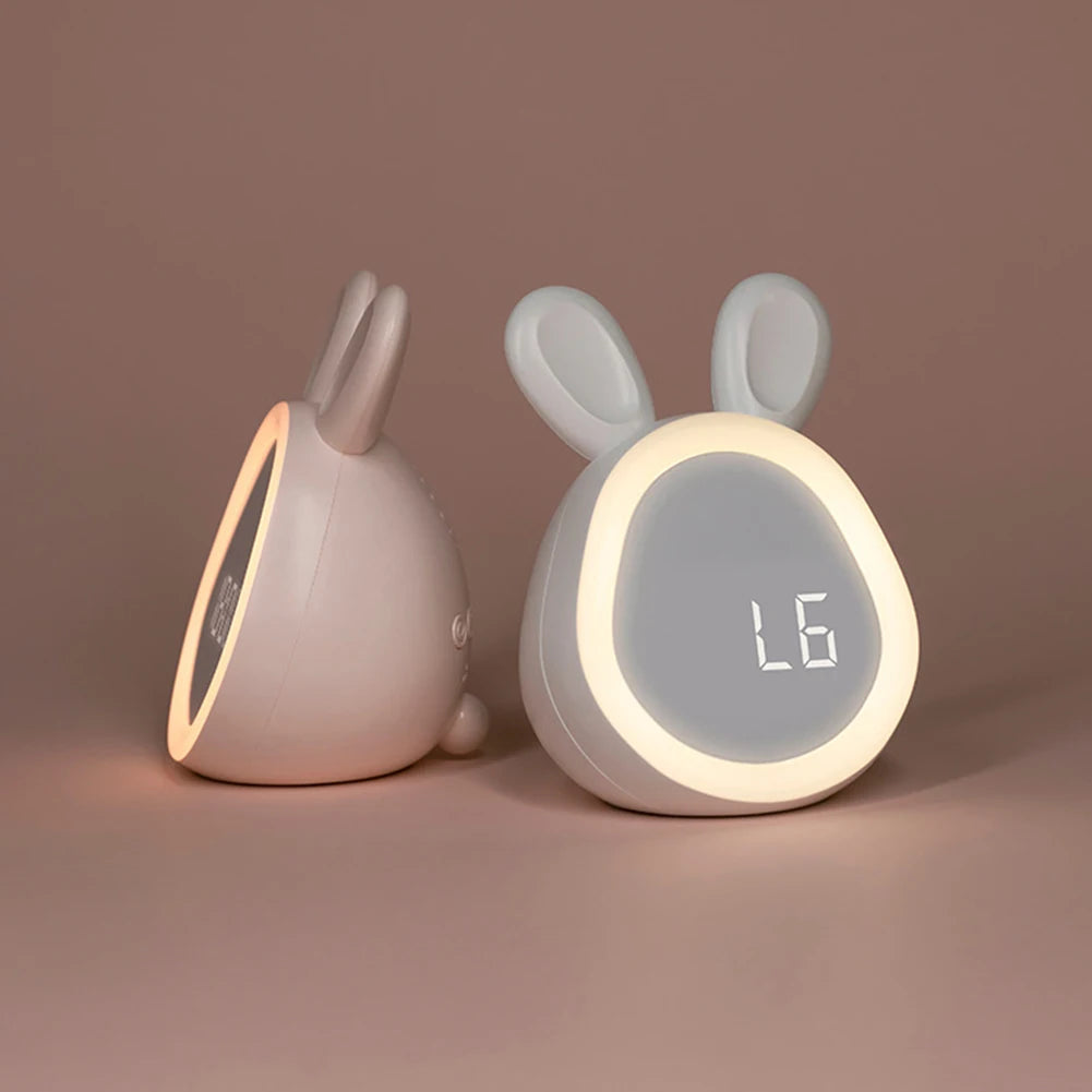 Two rabbit-shaped kawaii night lights with digital displays on a brown background