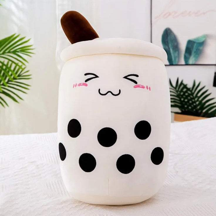 Cute kawaii plush toy resembling a bubble tea cup with a face on a white surface.