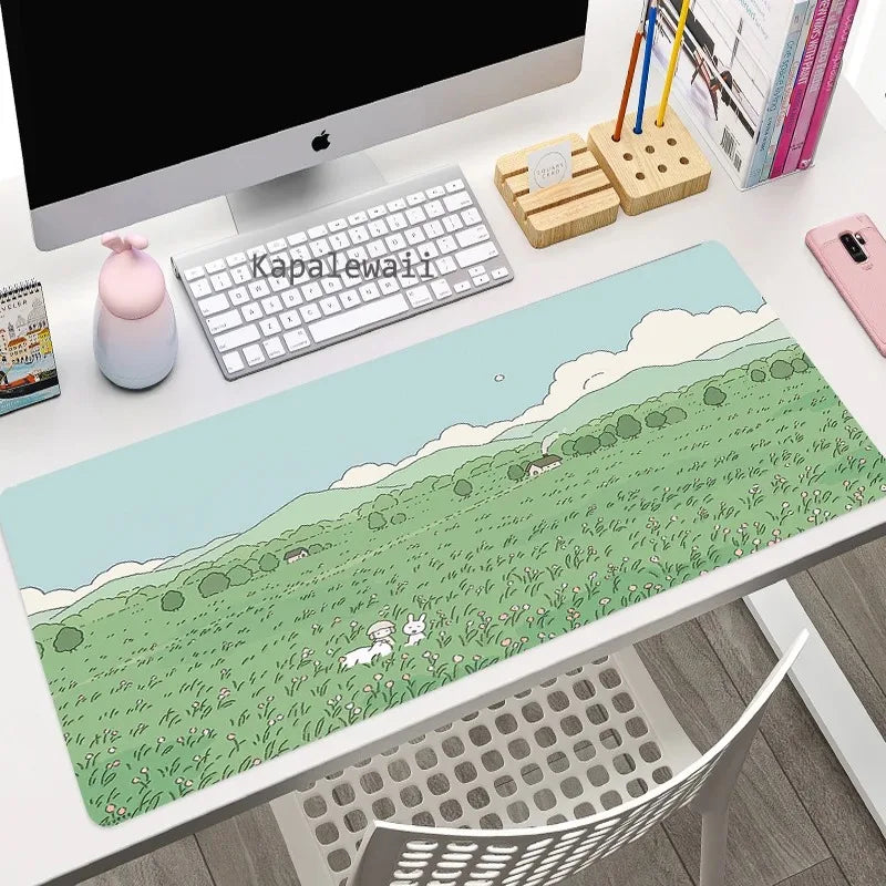 Desk setup with a large desk mat featuring a scenic design of a Kawaii rabbit in a field.