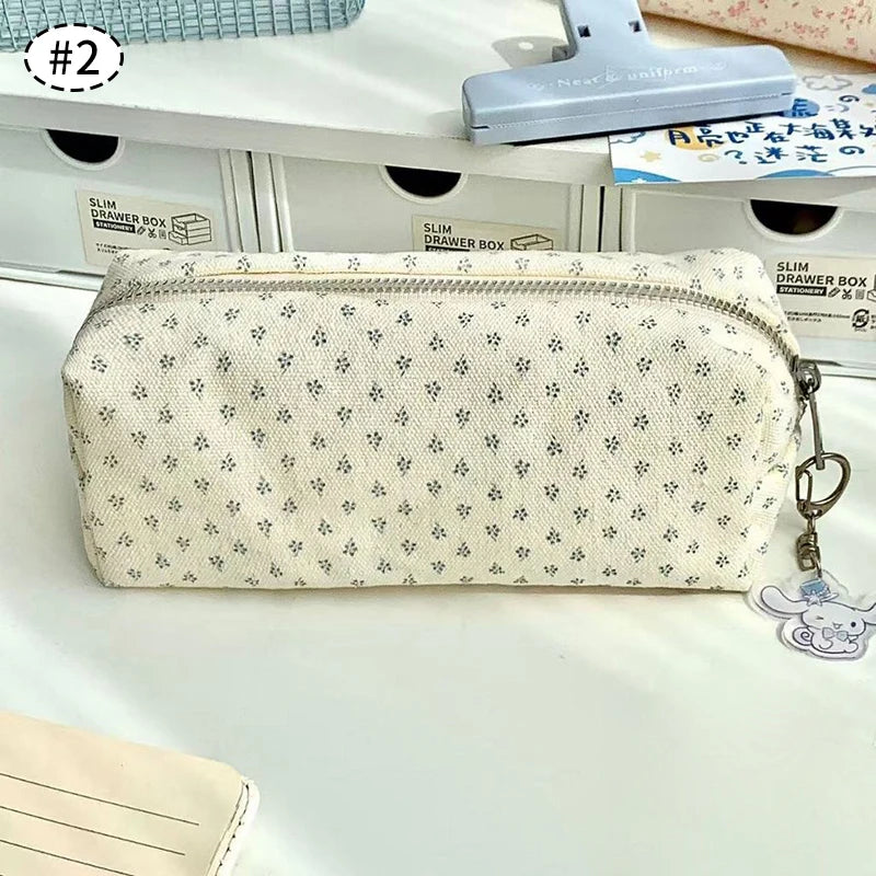 White floral-patterned kawaii pouch with a keychain on a white surface