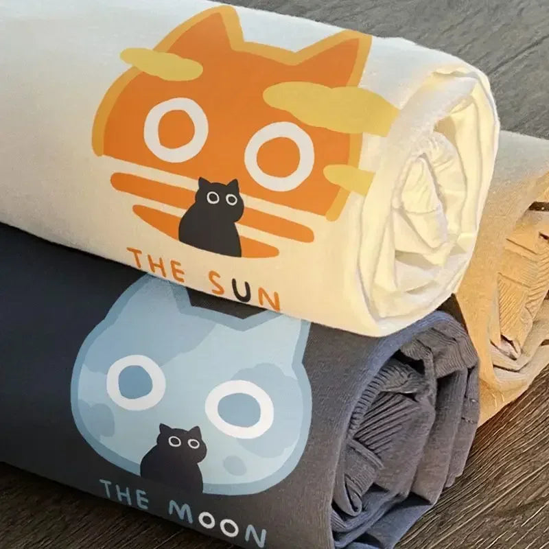 Roll of fabric with kawaii cat illustrations on 'The Sun' and 'The Moon'