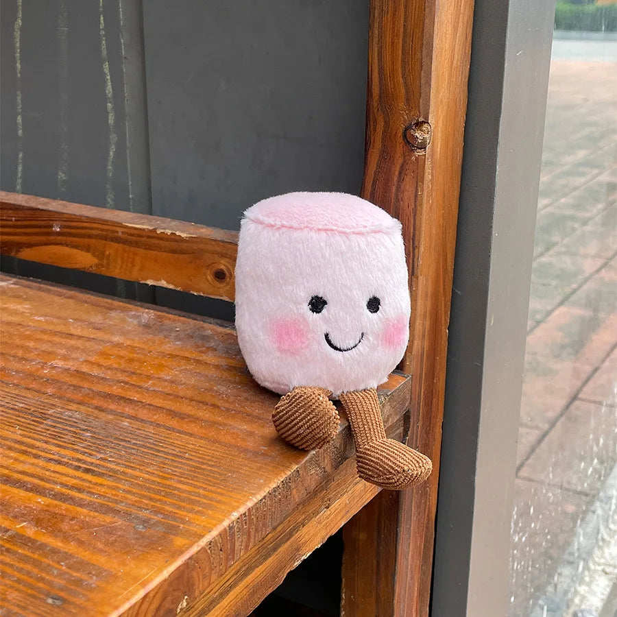Kawaii plush toy with a smiling face on a wooden bench