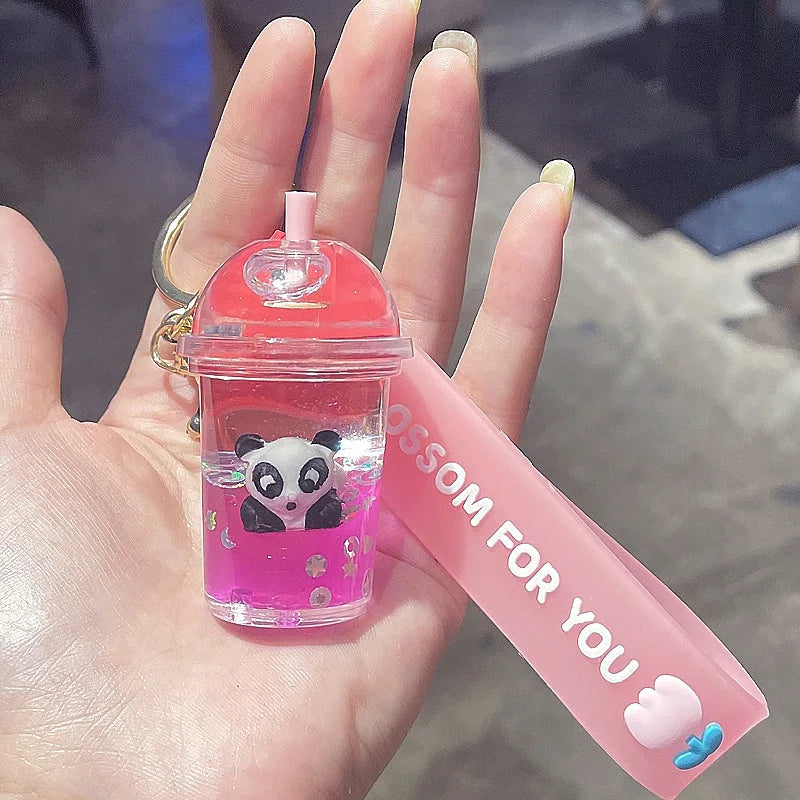 Small pink bottle with kawaii panda design held in a hand, with a pink card in the background.