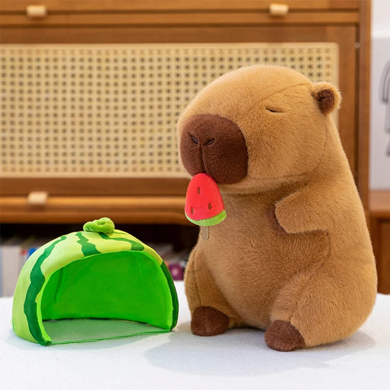 Kawaii plush bear holding a watermelon slice next to a green watermelon-shaped tent on a light surface.