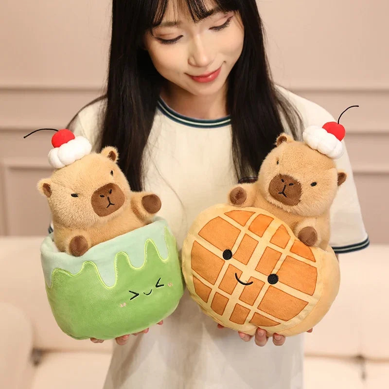 Person holding two kawaii plush toys shaped like a bear in a cake and waffle
