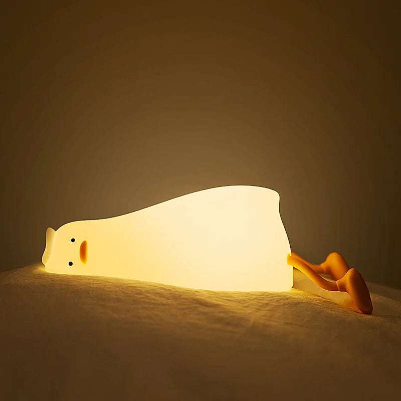 White cat-shaped kawaii night light on a dark background