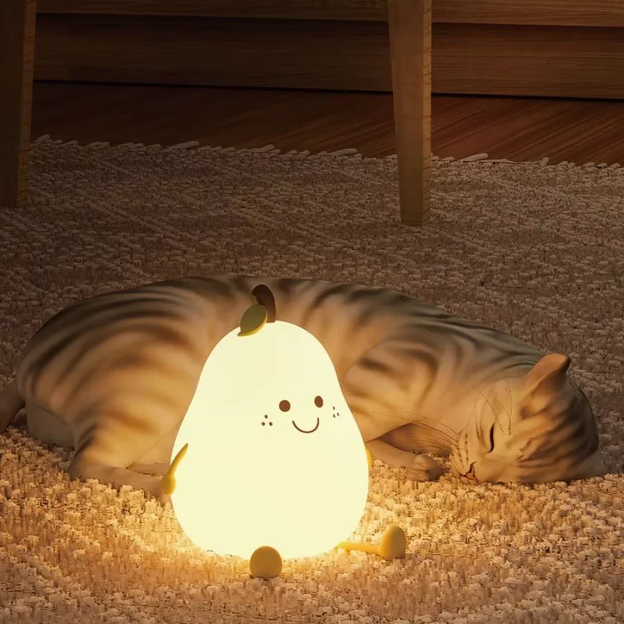 Cat lying on a carpet next to a glowing kawaii night light shaped like a cartoon ghost.