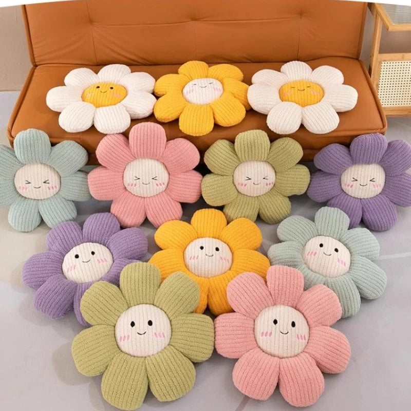 Colorful knitted flower-shaped kawaii cushions with smiling faces on a light background.