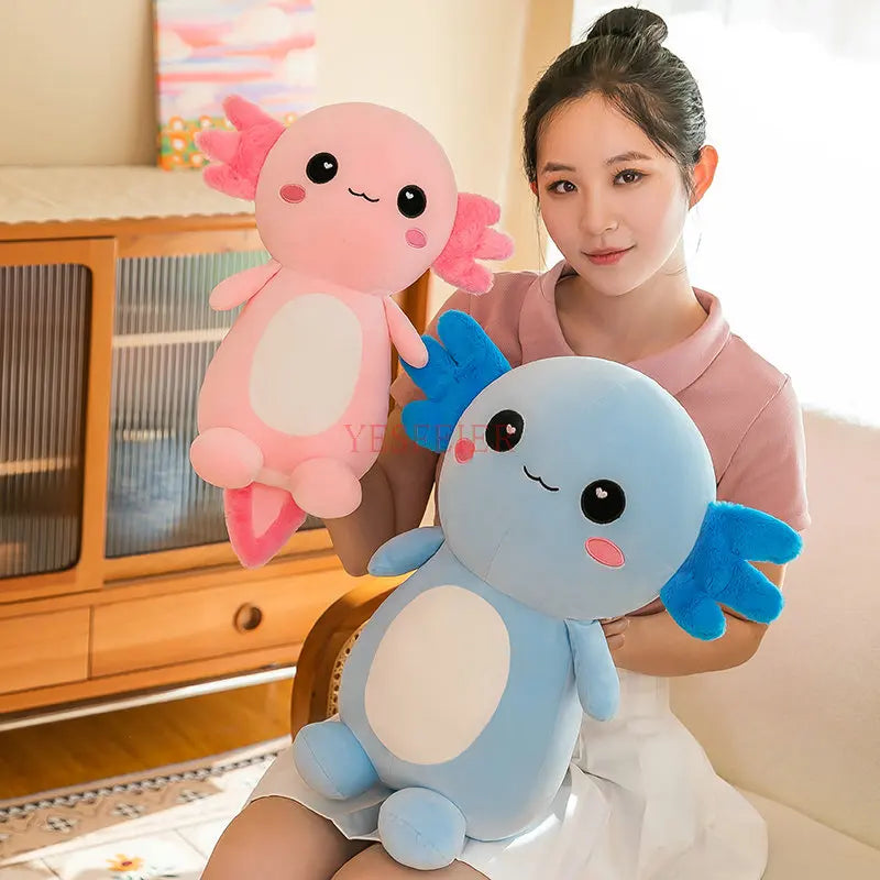 Person holding two axolotl kawaii plush toys in a living room setting