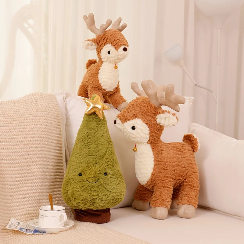Two plush deer kawaii toys and a green pear-shaped pillow on a soft surface with a neutral background.