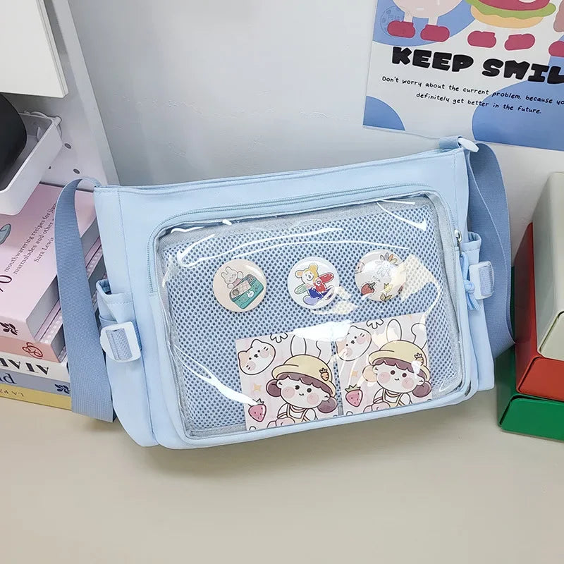 Light blue pouch with Kawaii cartoon designs on a desk