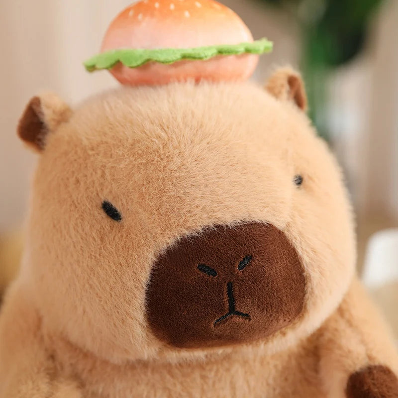 Kawaii plush toy resembling a beaver with a carrot on its head against a blurred background