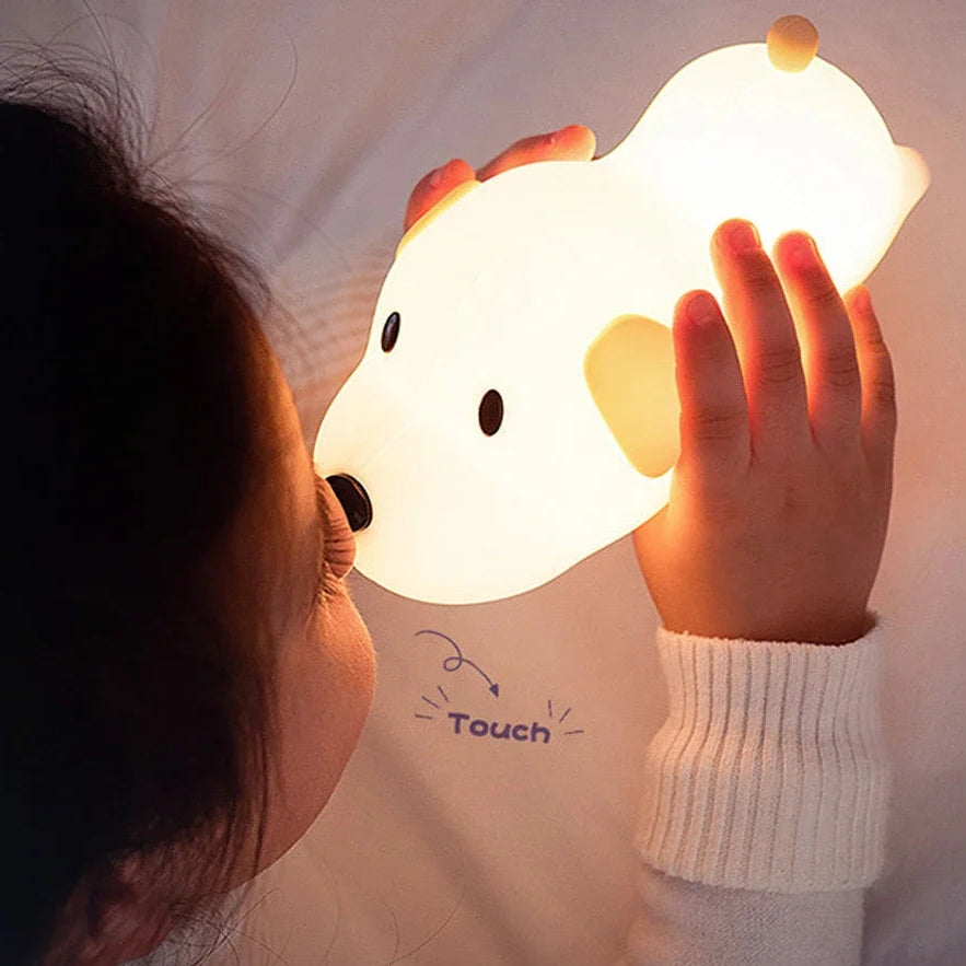 Person holding a soft, glowing dog-shaped kawaii night light
