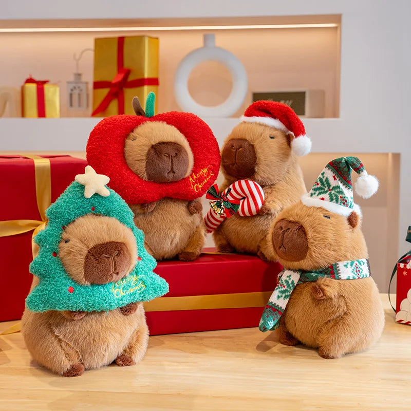 Four kawaii plush toys resembling dogs wearing festive hats and scarves on a wooden surface with gift boxes in the background.