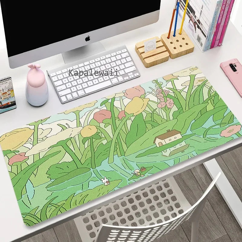 Desk setup with a decorative Kawaii mouse pad featuring a nature design.