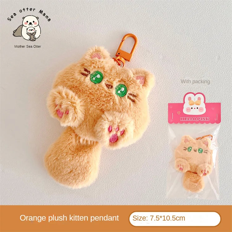 Orange kawaii plush kitten pendant with packaging on a light gray background