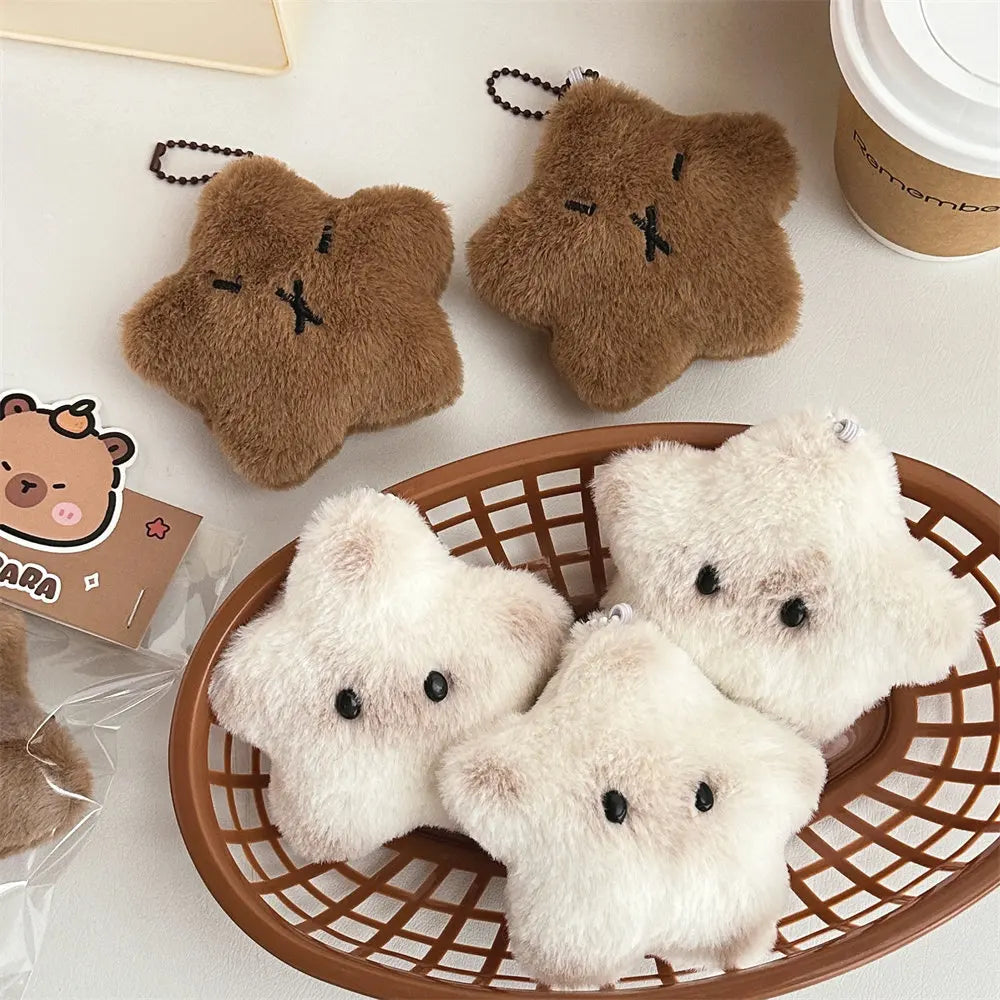Plush kawaii bear toys in a basket with a coffee cup and card in the background