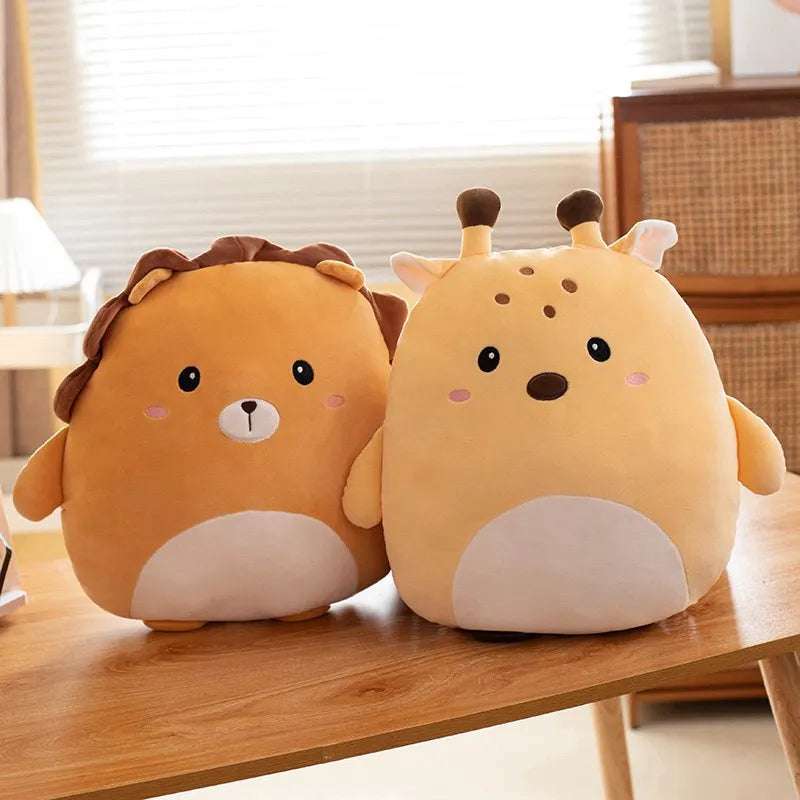 Two cute kawaii animal-shaped cushions on a wooden surface with a blurred indoor background.