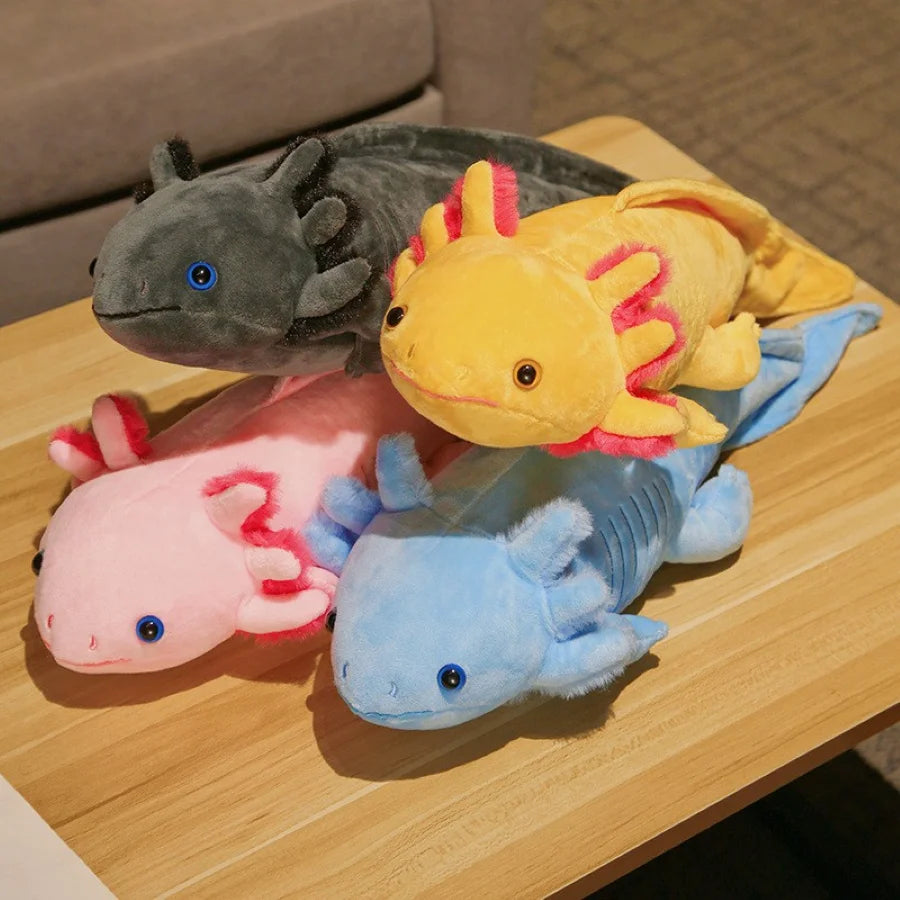 Four colorful axolotl kawaii plush toys on a wooden surface.