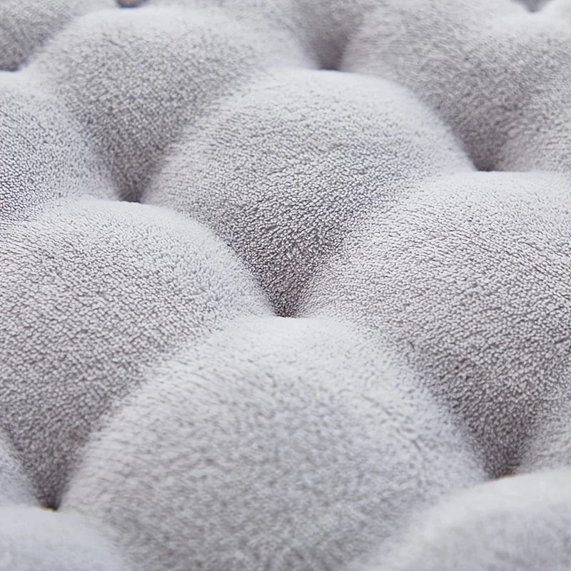 Close-up of a textured gray kawaii cushion with raised tufted design