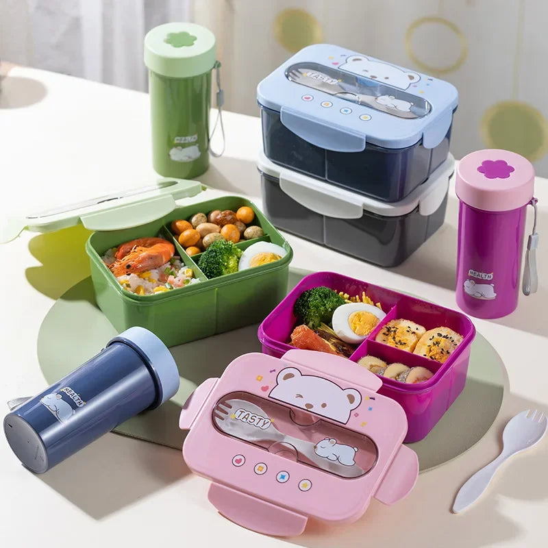 Set of colorful kawaii bento boxes and lunch containers with food on a table.